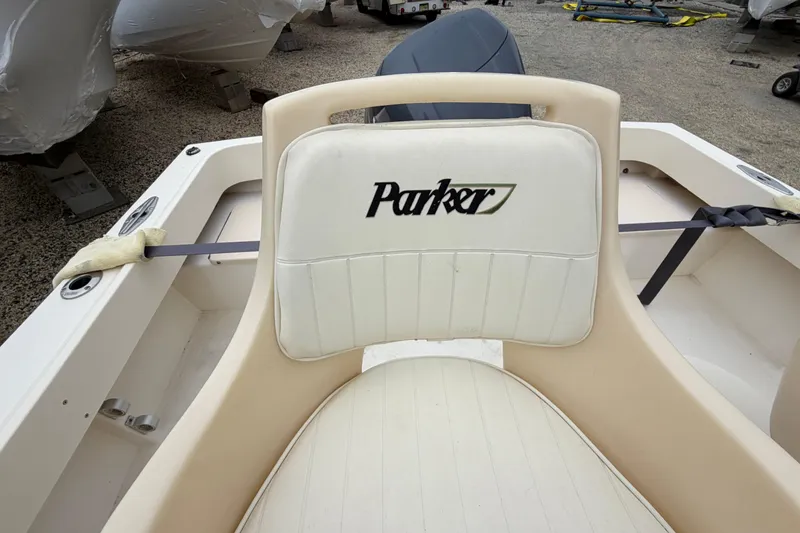 Slide: The Image of 2003 Parker 21SE Center Console boat seat with logo, in a storage area. - 40