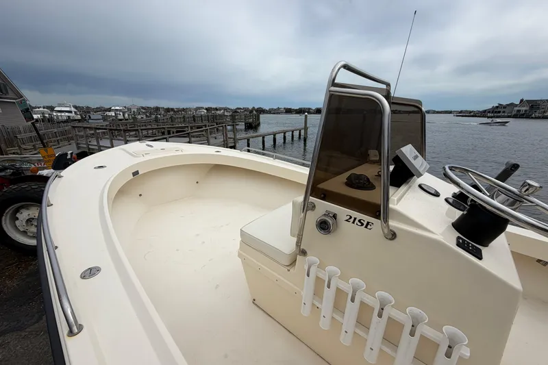 Slide: The Image of 2003 Parker 21SE Center Console boat docked by the waterfront. - 42