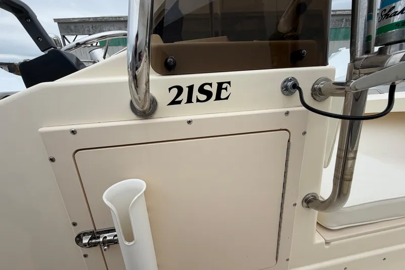 Slide: The Image of 2003 Parker 21SE Center Console boat detail with rod holder and control panel. - 47