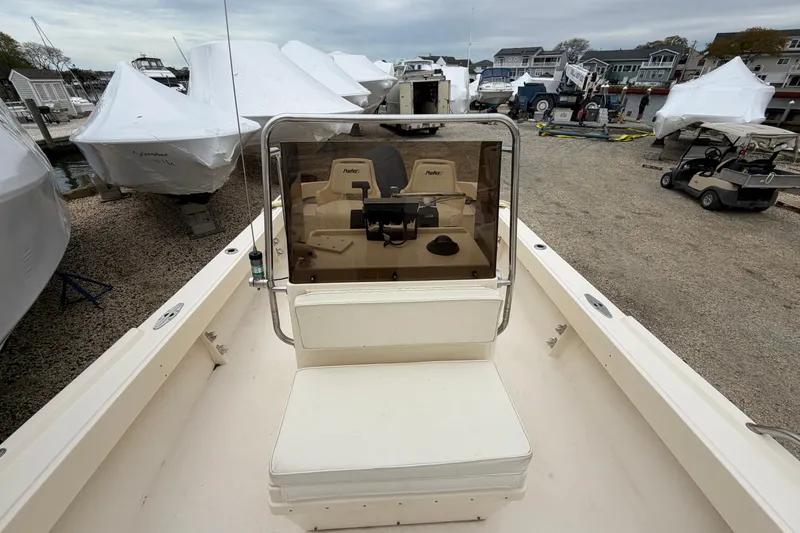 Slide: The Image of 2003 Parker 21SE Center Console boat in a marina with covered vessels. - 48