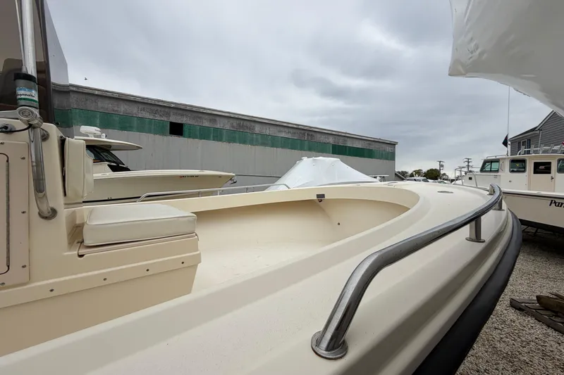 Slide: The Image of 2003 Parker 21SE Center Console boat in a marina, overcast sky. - 49