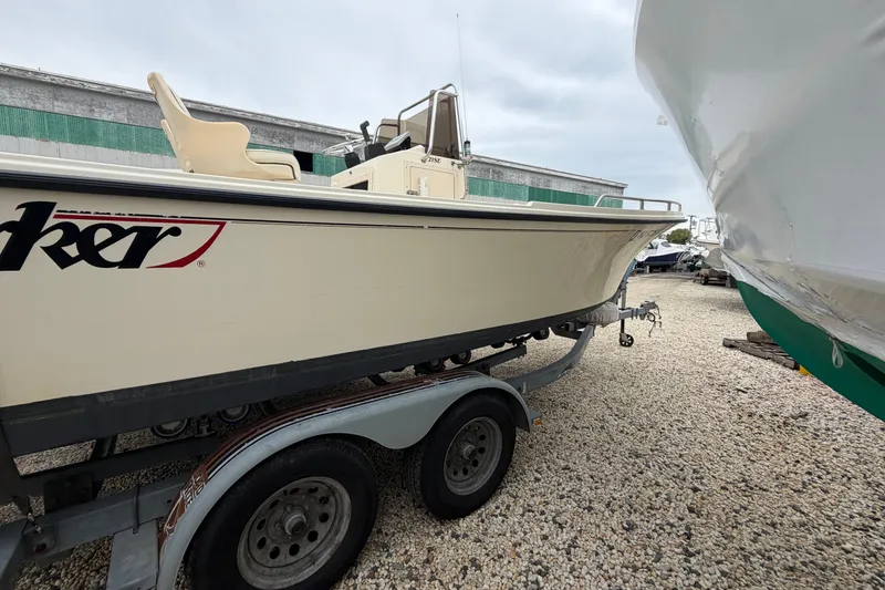 Slide: The Image of 2003 Parker 21SE Center Console boat on trailer, parked on gravel lot. - 5