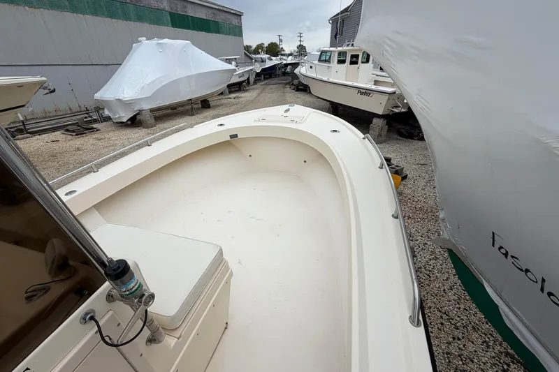 Slide: The Image of 2003 Parker 21SE Center Console boat in storage yard, surrounded by covered boats. - 50