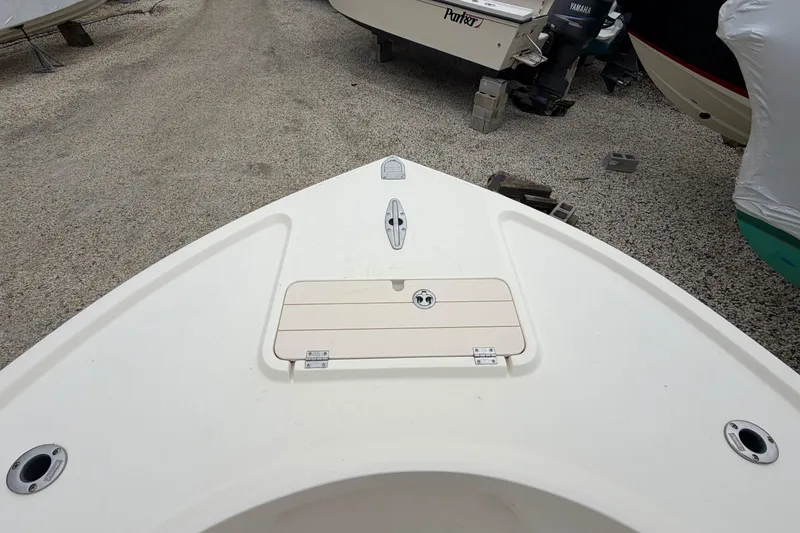 Slide: The Image of Bow view of a 2003 Parker 21SE Center Console boat on gravel. - 56