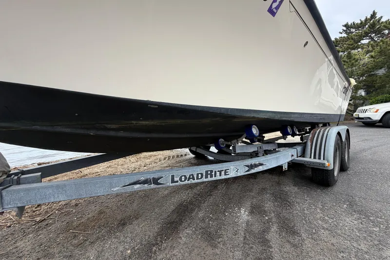 Slide: The Image of 2003 Parker 21SE Center Console boat on Load Rite trailer, parked on a paved surface. - 9