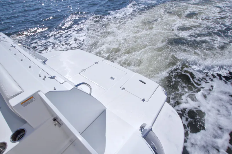 Slide: The Image of 2008 Cruisers Yachts 420 Express boat stern on water, showcasing sleek design and wake. - 11