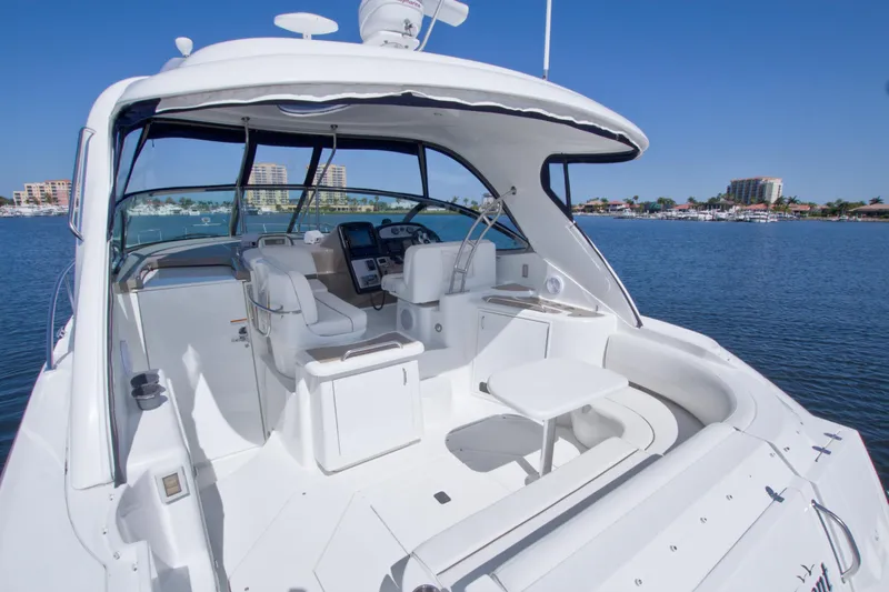 Slide: The Image of 2008 Cruisers Yachts 420 Express, luxurious white interior, docked on calm waters. - 13