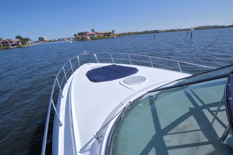Slide: The Image of 2008 Cruisers Yachts 420 Express on calm water, showcasing sleek deck design and scenic surroundings. - 14