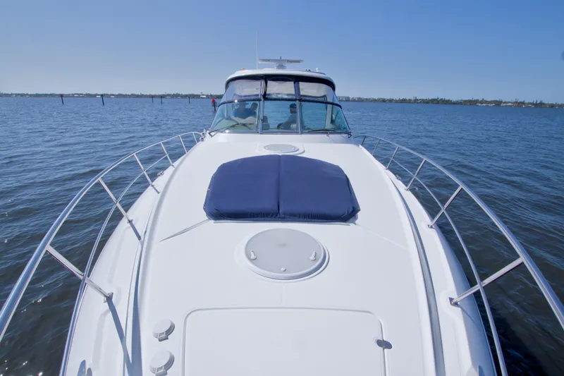 Slide: The Image of 2008 Cruisers Yachts 420 Express on calm water, showcasing sleek design and spacious deck. - 18