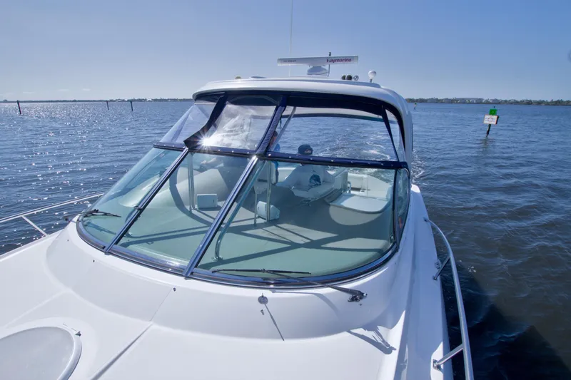 Slide: The Image of 2008 Cruisers Yachts 420 Express on calm water, showcasing sleek design and spacious cockpit. - 19