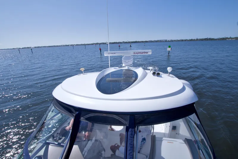 Slide: The Image of 2008 Cruisers Yachts 420 Express on calm water, showcasing sleek design and radar equipment. - 20