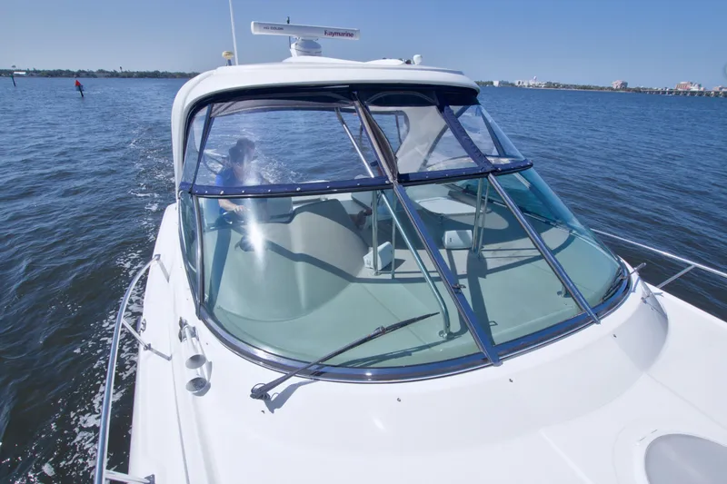 Slide: The Image of 2008 Cruisers Yachts 420 Express on open water, showcasing sleek design and spacious cockpit. - 21