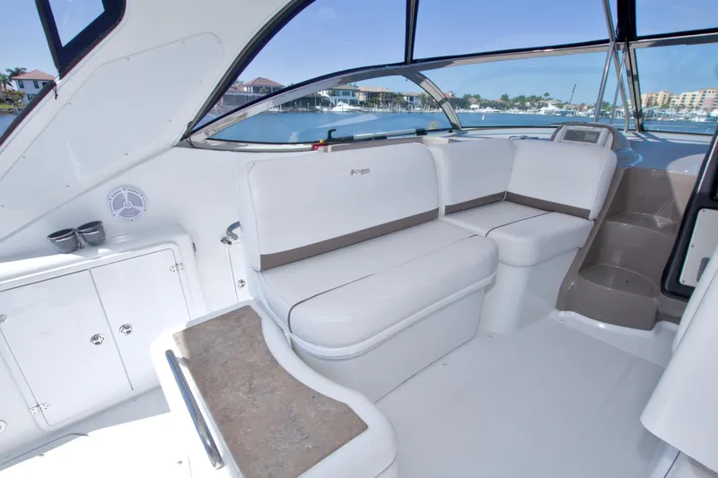 Slide: The Image of 2008 Cruisers Yachts 420 Express interior with white seating and waterfront view. - 26