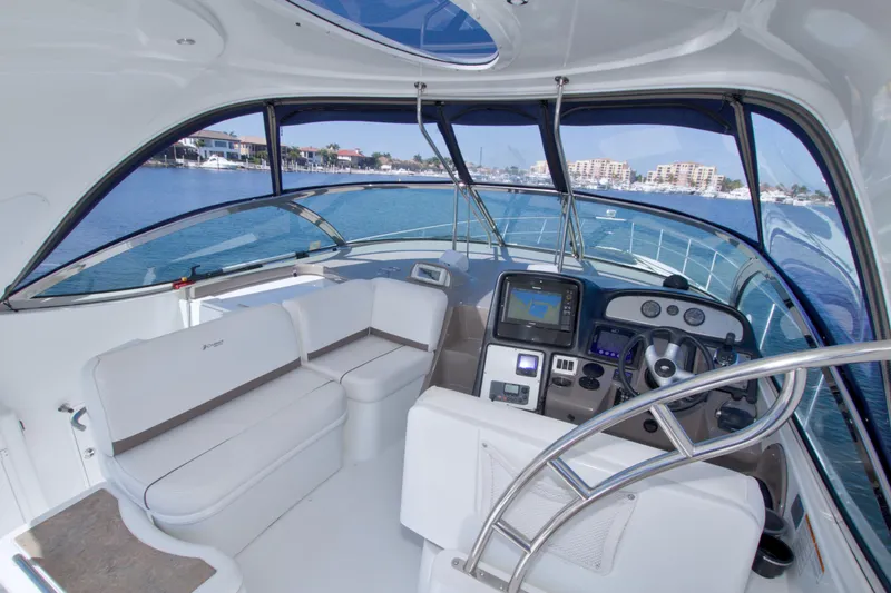 Slide: The Image of 2008 Cruisers Yachts 420 Express cockpit with modern navigation system and waterfront view. - 27