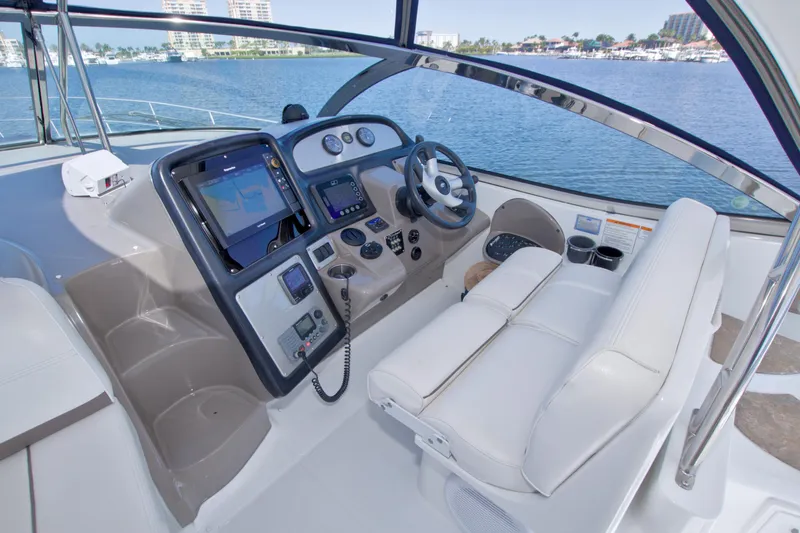 Slide: The Image of 2008 Cruisers Yachts 420 Express helm with navigation equipment and waterfront view. - 28