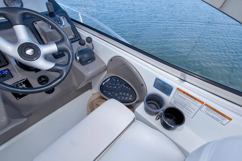 Slide: The Image of 2008 Cruisers Yachts 420 Express helm with steering wheel and control panel. - 31