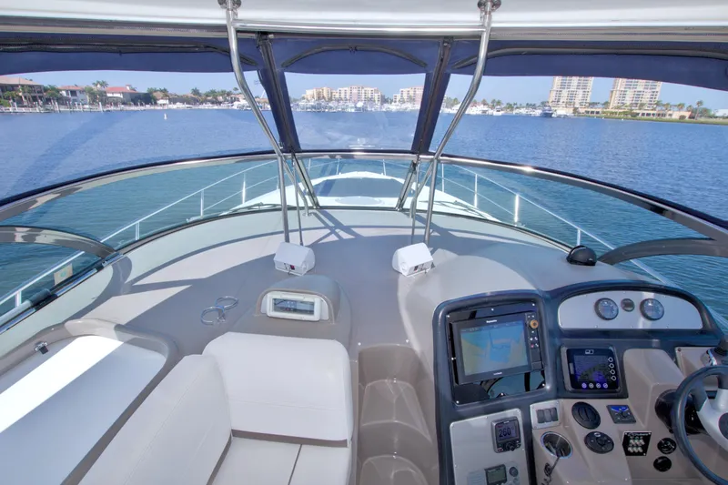 Slide: The Image of 2008 Cruisers Yachts 420 Express helm with navigation equipment, cruising on a sunny day. - 32