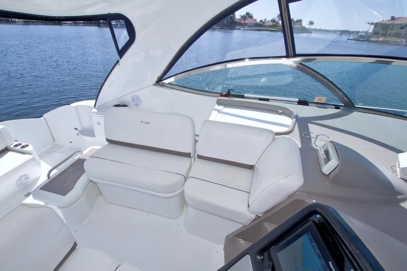 Slide: The Image of 2008 Cruisers Yachts 420 Express interior with white seating and waterfront view. - 33