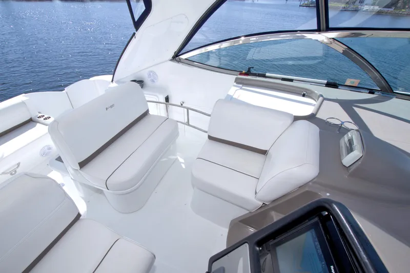 Slide: The Image of 2008 Cruisers Yachts 420 Express interior with white seating and panoramic windows. - 34