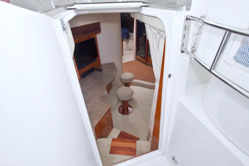 Slide: The Image of Interior view of 2008 Cruisers Yachts 420 Express, featuring seating and entertainment area. - 36