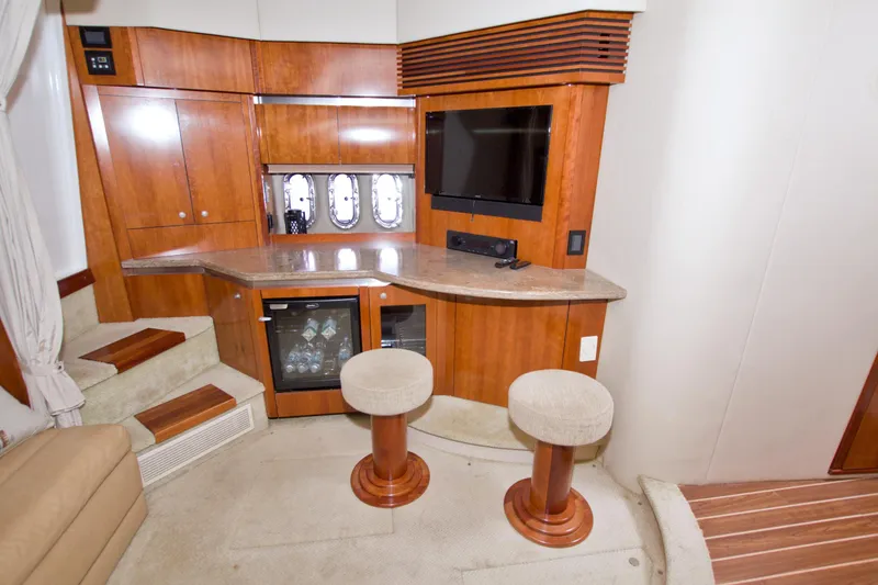 Slide: The Image of Luxurious 2008 Cruisers Yachts 420 Express interior with bar, stools, and entertainment area. - 37