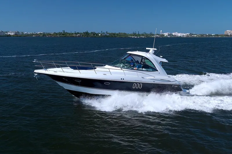 Slide: The Image of 2008 Cruisers Yachts 420 Express cruising on open water under clear blue skies. - 4