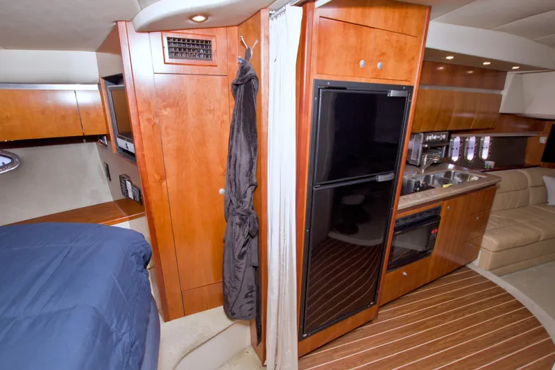 Slide: The Image of Interior of 2008 Cruisers Yachts 420 Express with kitchen and seating area. - 43