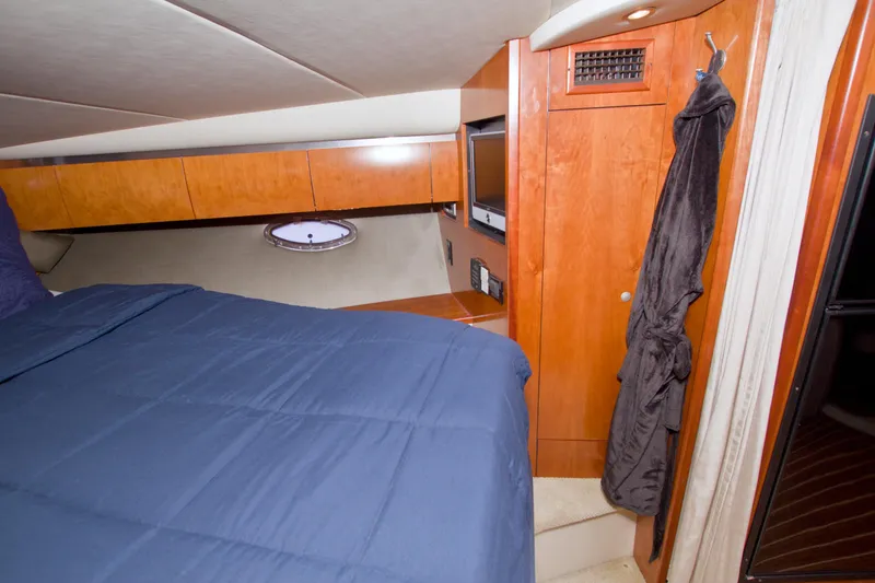 Slide: The Image of Luxurious cabin interior of 2008 Cruisers Yachts 420 Express with wood finish and cozy bedding. - 44
