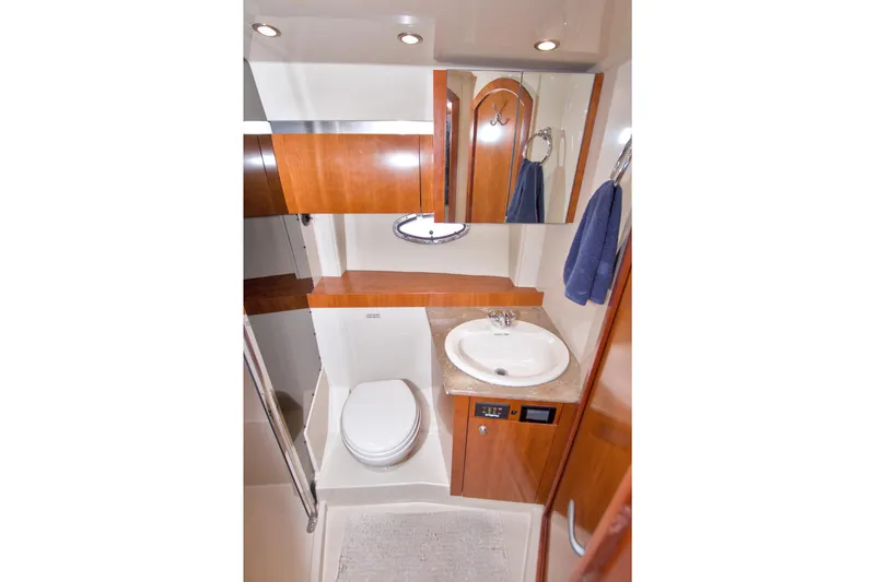 Slide: The Image of Luxurious bathroom in 2008 Cruisers Yachts 420 Express with wood cabinetry and modern fixtures. - 48