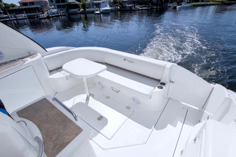 Slide: The Image of 2008 Cruisers Yachts 420 Express boat deck with seating and table, overlooking calm waters. - 51