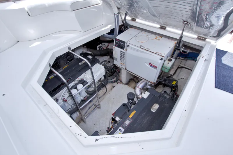 Slide: The Image of Engine compartment of 2008 Cruisers Yachts 420 Express, featuring generator and mechanical components. - 52