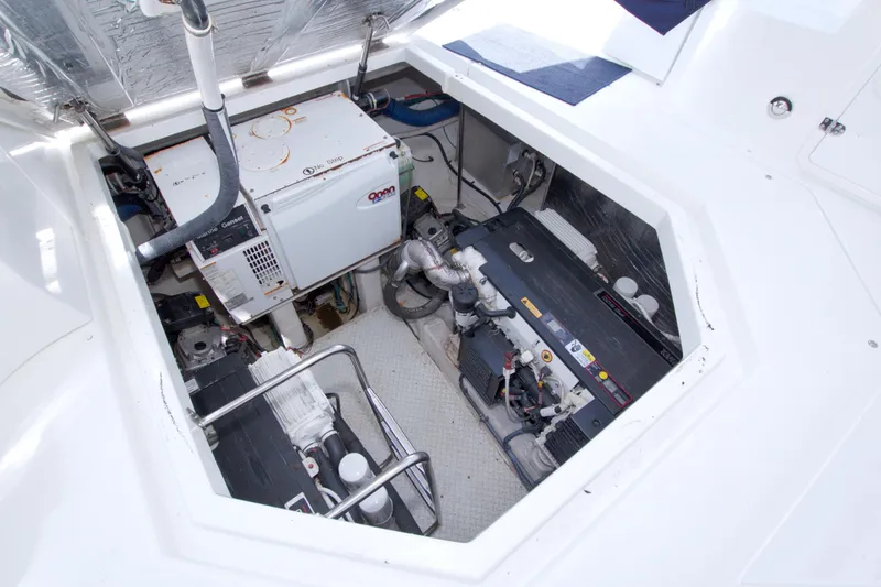 Slide: The Image of Engine compartment of 2008 Cruisers Yachts 420 Express, showcasing generator and machinery. - 53
