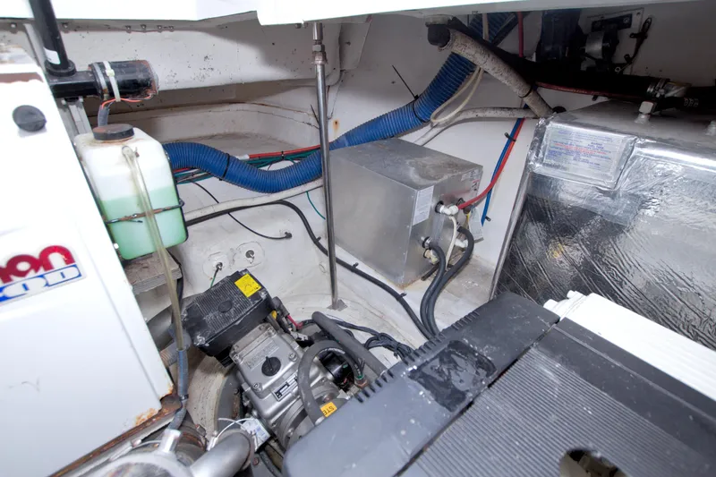 Slide: The Image of Engine compartment of 2008 Cruisers Yachts 420 Express, showcasing mechanical components and wiring. - 56