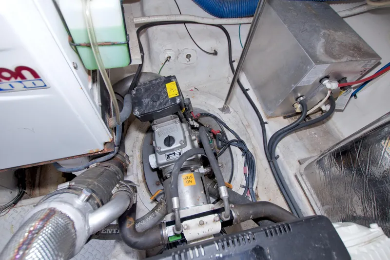 Slide: The Image of Engine compartment of 2008 Cruisers Yachts 420 Express, showcasing mechanical components and wiring. - 57