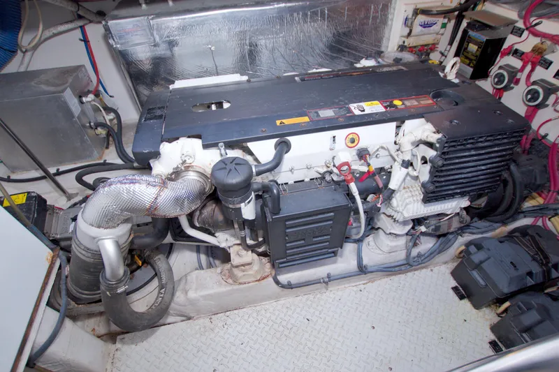 Slide: The Image of Engine room of a 2008 Cruisers Yachts 420 Express, showcasing mechanical components and wiring. - 58