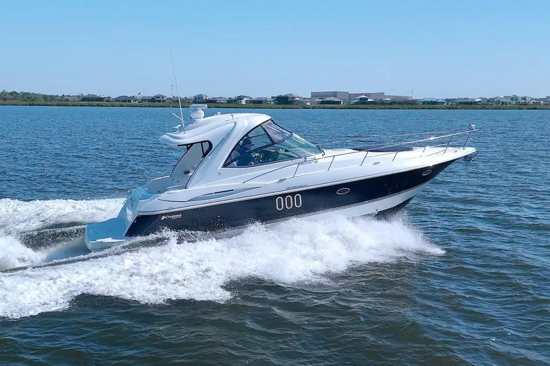 Slide: The Image of 2008 Cruisers Yachts 420 Express cruising on open water, clear sky background. - 6