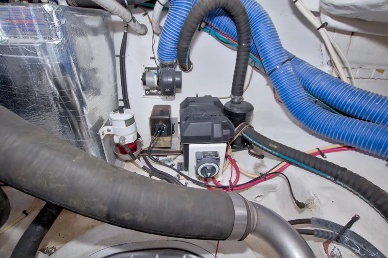 Slide: The Image of Engine room of 2008 Cruisers Yachts 420 Express with hoses and electrical components. - 68