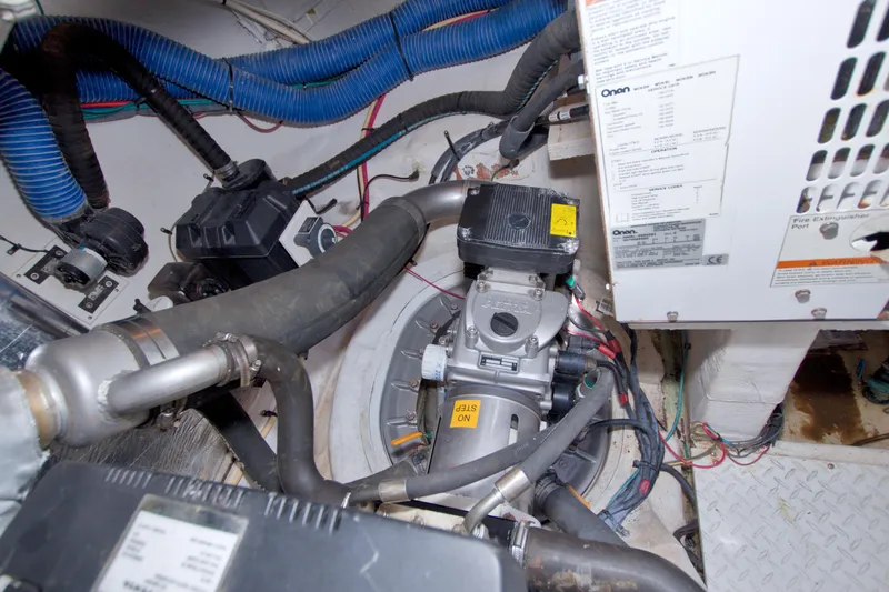 Slide: The Image of Engine room of 2008 Cruisers Yachts 420 Express, featuring mechanical components and wiring. - 69