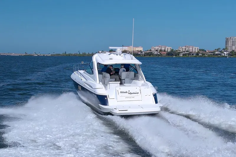 Slide: The Image of 2008 Cruisers Yachts 420 Express cruising on a sunny day near coastal buildings. - 8