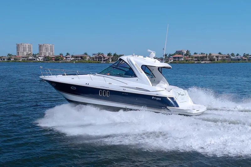 Slide: The Image of 2008 Cruisers Yachts 420 Express cruising on a sunny day near waterfront homes. - 9