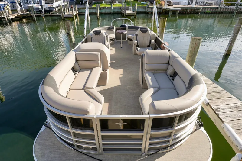 Slide: The Image of 2023 Berkshire 24 RFX LE 2.75 pontoon boat with spacious seating at dock. - 11
