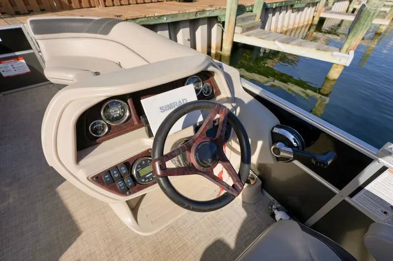 Slide: The Image of 2023 Berkshire 24 RFX LE 2.75 boat dashboard with steering wheel and controls. - 5