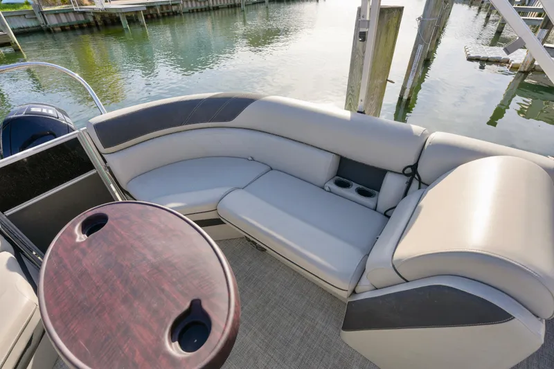 Slide: The Image of 2023 Berkshire 24 RFX LE 2.75 pontoon boat interior with plush seating and table. - 7