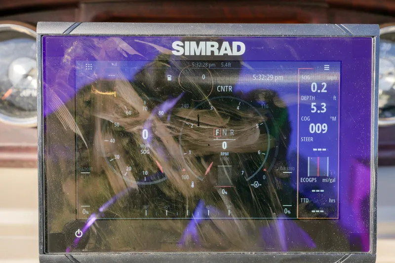 Slide: The Image of Simrad display on 2023 Berkshire 24 RFX LE 2.75 boat dashboard showing navigation data. - 9