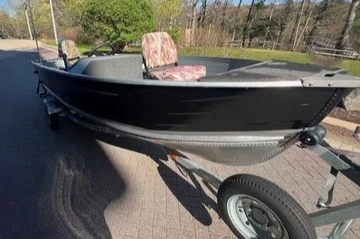 Slide: The Image of 2017 Starcraft Seafarer 14 DLX SC boat on trailer, parked outdoors. - 4