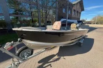 Slide: The Image of 2017 Starcraft Seafarer 14 DLX SC boat on trailer, parked outdoors. - 6
