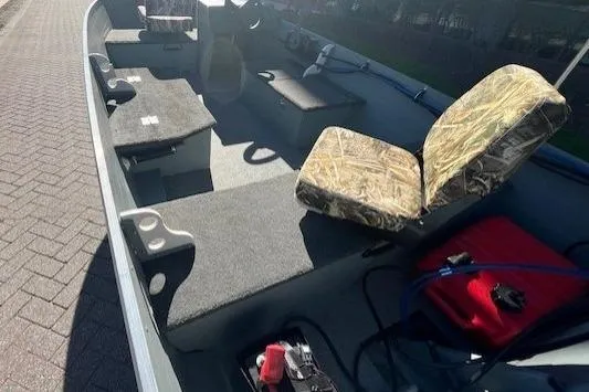 Slide: The Image of 2017 Starcraft Seafarer 14 DLX SC boat interior with camo seats and storage compartments. - 7