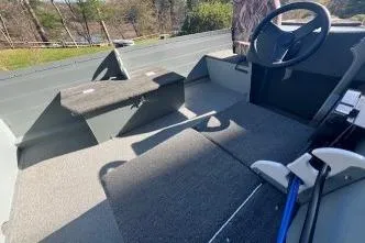 Slide: The Image of 2017 Starcraft Seafarer 14 DLX SC boat interior with steering wheel and seating. - 8
