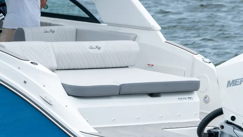 Slide: The Image of 2026 Sea Ray SDX 230 Outboard boat with luxurious seating area. - 19