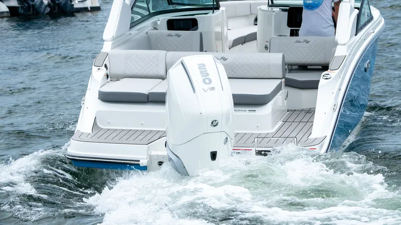 Slide: The Image of 2026 Sea Ray SDX 230 Outboard on water, rear view. - 21